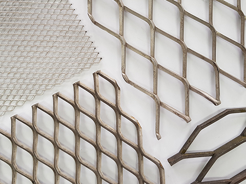 Expanded Metal is produced from a solid sheet or plate of a variety of metals and metal
alloys. In the expanding process, the sheet or plate is simultaneously slit and stretched
longitudinally to form a regular pattern of diamond-shaped openings. No material is lost in the expanding process. The strands and knuckles of the diamond-shaped screen form an angle to the original plane of the sheet, making the final product stronger in terms of weight and lighter in terms of length than the original sheet or plate.
Expanded Metal’s unique combination of strength and stylish design makes the material a popular choice for engineers and architects. Its durability and cost-effectiveness are ideal for structural support and security applications such as enclosures, catwalks and plaster base or reinforcements for walls and partitions.
Moreover, Expanded Metal’s stylish appearance can turn a plain, minimally-designed structure into a work of art. Due to this, the material has become increasingly popular for aesthetic applications and can be seen on both the exterior and interior of buildings as facade cladding, ceiling panels, dividers, balustrades and many more.